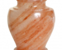 The Carpel Rock Salt urn is a full-capacity urn that is a perfect vessel for a natural disposition. It’s a 100% bio-degradable urn made out of natural Rock Salt. Designed for sea burials or water funerals; guaranteed to dissolve in four hours.

This urn has a natural color of many shades of red and orange with slight white/clear highlights.

Each urn is made from one block of stone and not pieced together; this helps to prevent the urn from cracking and allows the urn to be seamless. The matching lid opens from the top and can be sealed permanently when ready.

Each urn takes 5 hours to be manufactured, making each urn a true piece of art. Pricing: $395 includes shipping. 